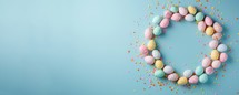 Easter eggs in pastel colors on blue background. Easter concept. Flat lay, top view, copy space.