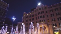 children playing in fountains at night 