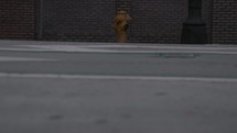 yellow fire hydrant and passing cars 
