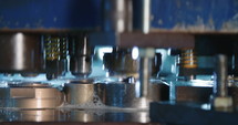 Close up shot of a punch press forming metal parts