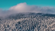 Clouds motion fast over frozen winter forest mountains nature Time-lapse background
