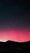 Vertical video of red aurora borealis motion in starry night sky in Europe Time lapse
