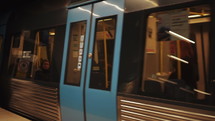 Underground train departs from modern subway station