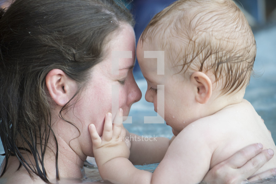 a mother in an infant in a swimming pool 