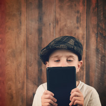 a child holding an tablet 