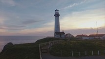 a lighthouse and coastline | direction | aerial | flight | motion 