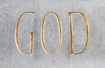 God written in golden font in stone