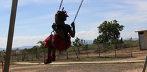 girl child swinging on a swing 