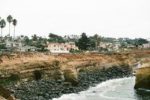 homes on cliffs along a shoreline 