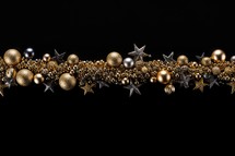 
Christmas garland with golden and silver baubles on black background