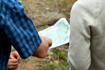 two men looking at a map 