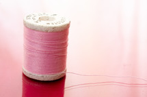 spool of pink thread 