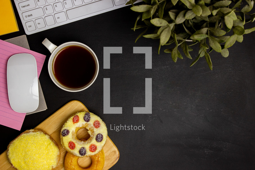computer keyboard and mouse with coffee and donut 