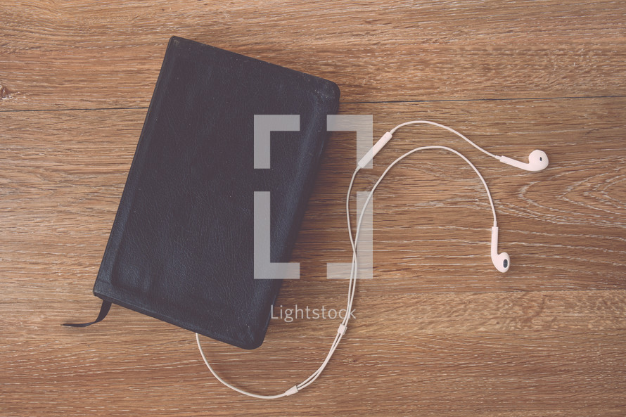 A Bible and earbuds 