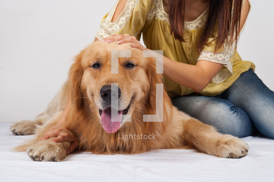 a girl petting her dog 