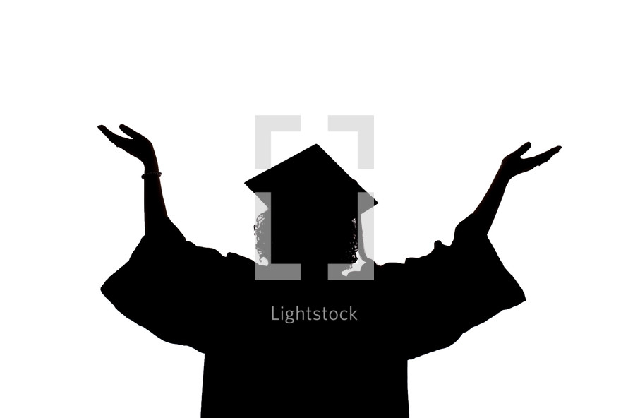 silhouette of a graduate with raised hands 