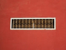 red wall and wire on a window 