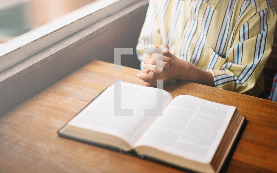 praying over an open Bible 