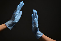 gloved hands high five - support for medical staff 