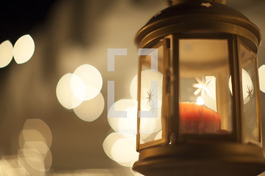 bokeh lights and candle in a lantern 