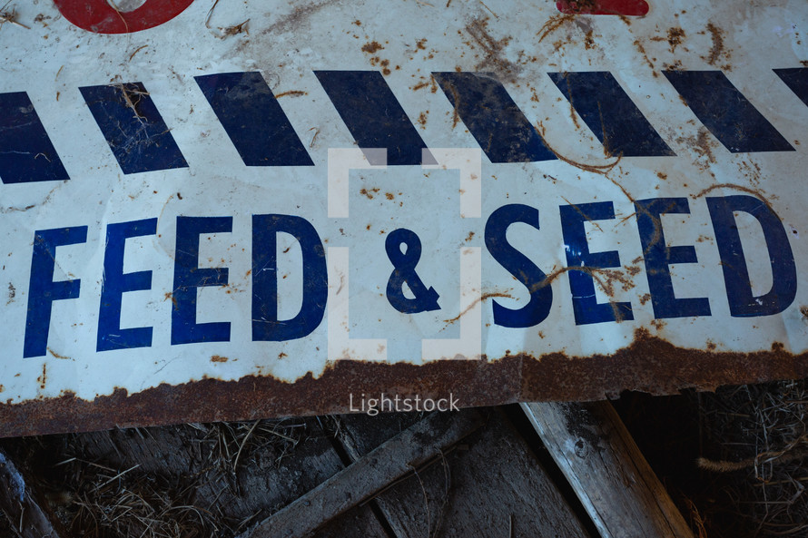 Old, trashed Feed and Seed sign