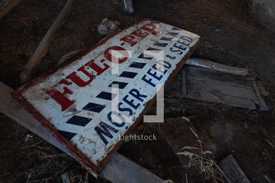Old, broken Feed and Seed sign