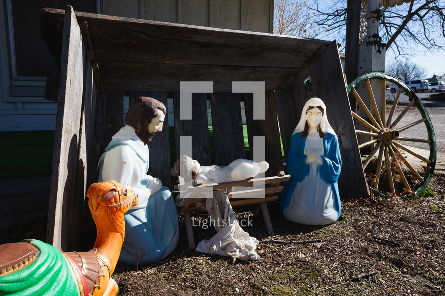 Plastic outdoors nativity scene with camel, mary, joseph, and Jesus