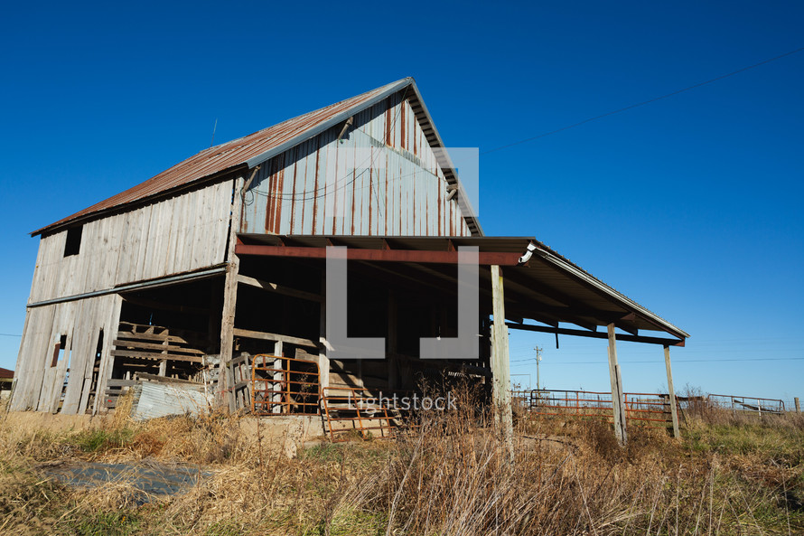 Wooden building with rust on the roof in rural area