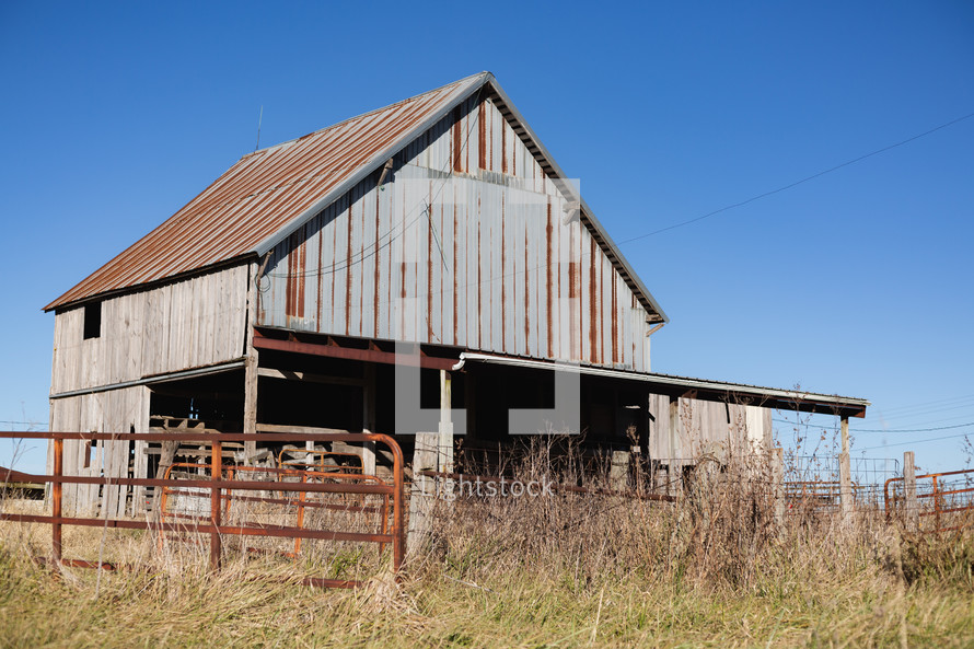 Wooden barn with metal roof in rural area