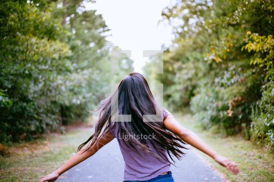 a girl running down a path 