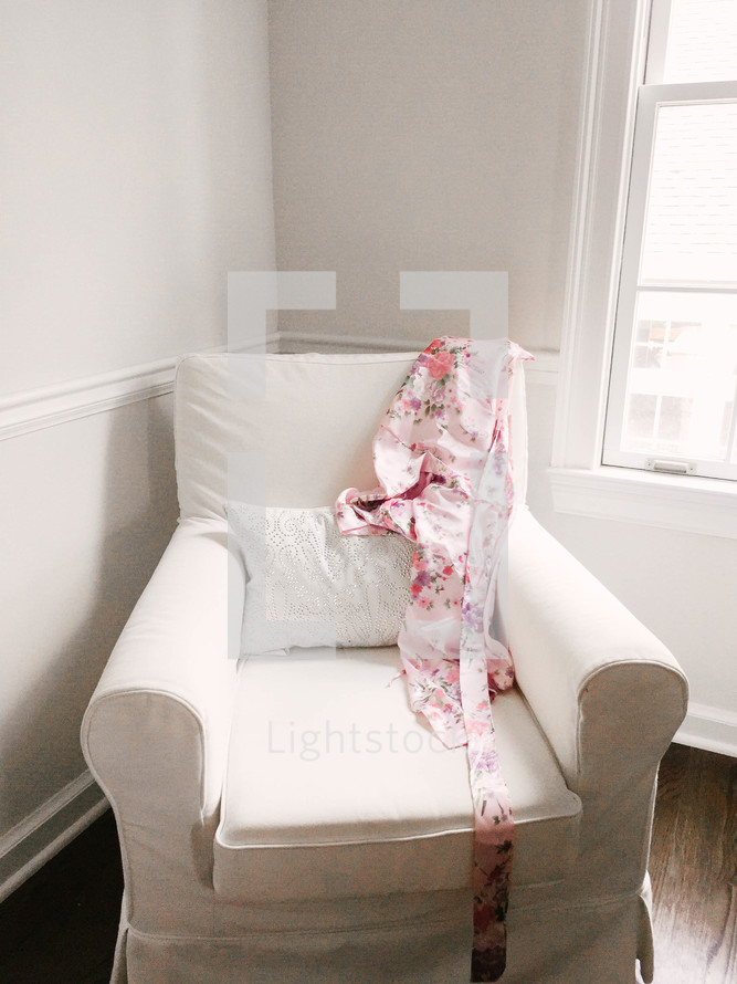 silk robe on a white arm chair 