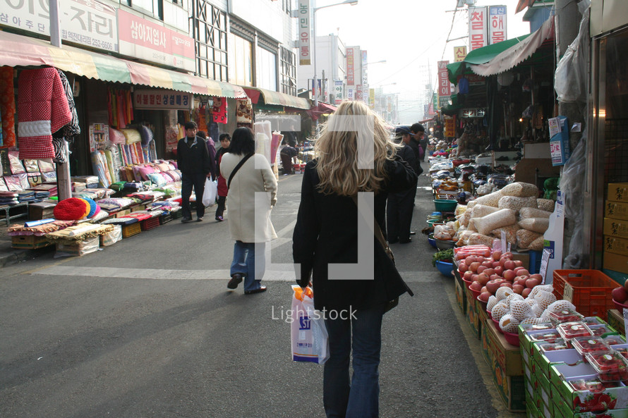 woman walking in a street market in Korea 