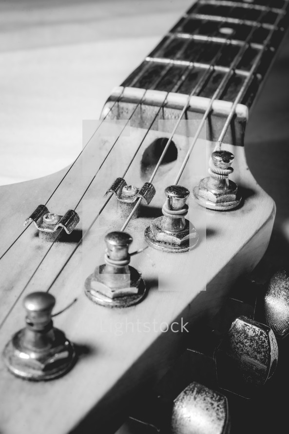 Close up from an old vintage guitar headstock , Full with dust. In black and white.