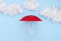 red umbrella against a blue sky background 