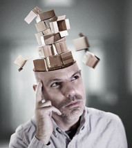 man lost in thought as his mind is filled with empty boxes.
