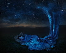 a woman sleeping under the stars 