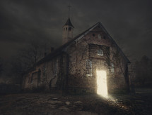a light glowing in the doorway of an abandoned church 