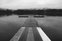 A wooden pier on a calm lake.