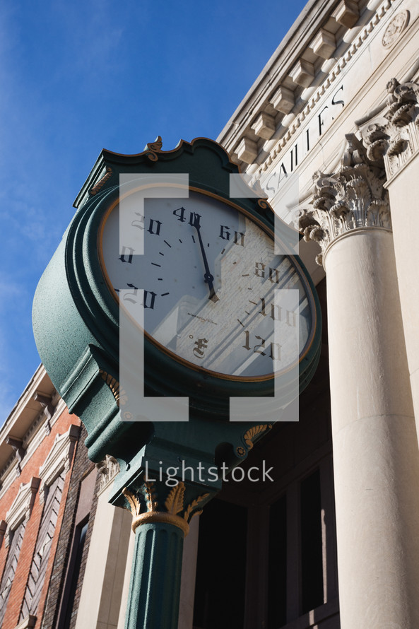 Old fashioned thermometer against bank building