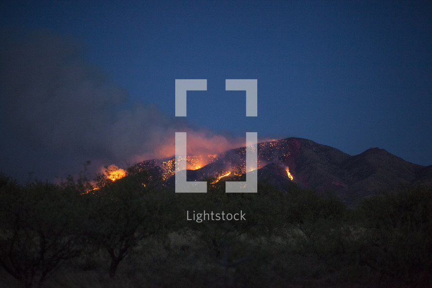 A mountain wildfire at night