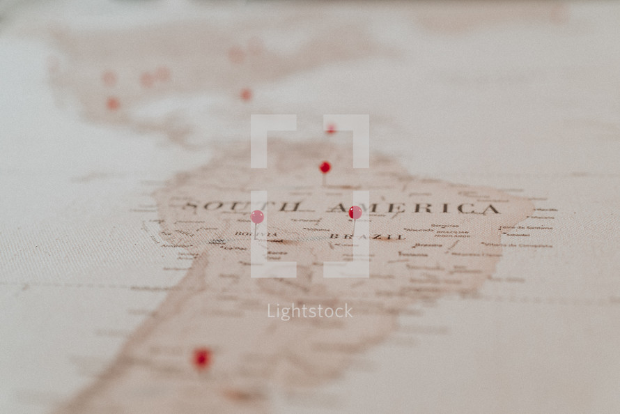 push-pins on a map of South America 