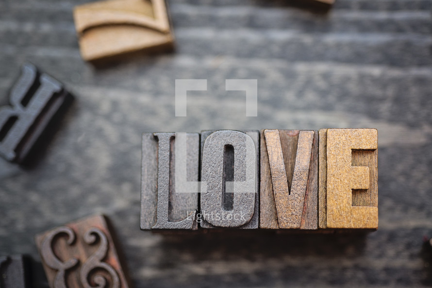 wooden print press stamps forming the word love 