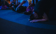 kneeling in surrender at a worship service 
