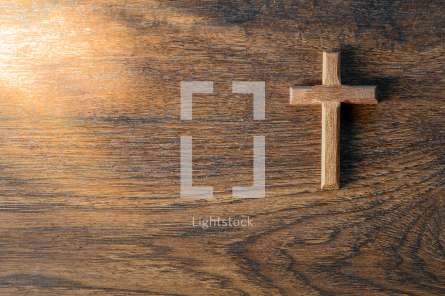 wooden cross on a wood background 