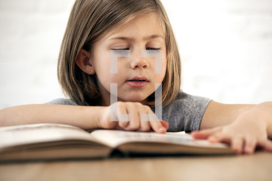 young kid reading a book.