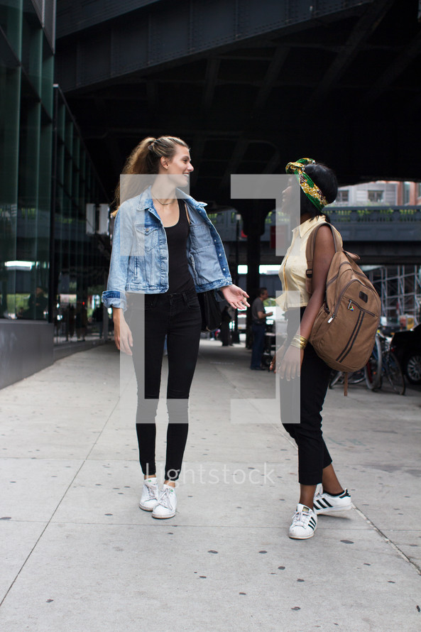 friends walking down a sidewalk 