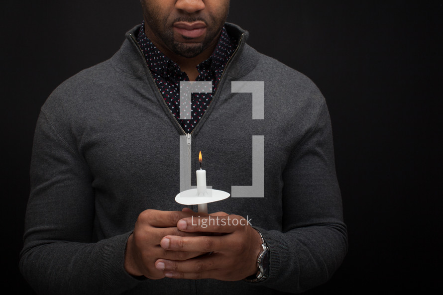 a man holding a candle 