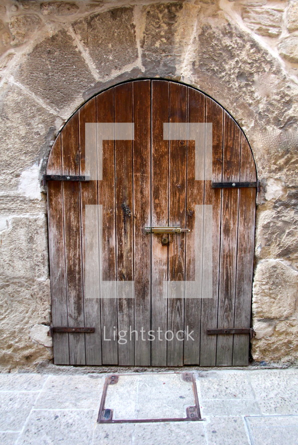 A wooden door to an ancient cathedral 