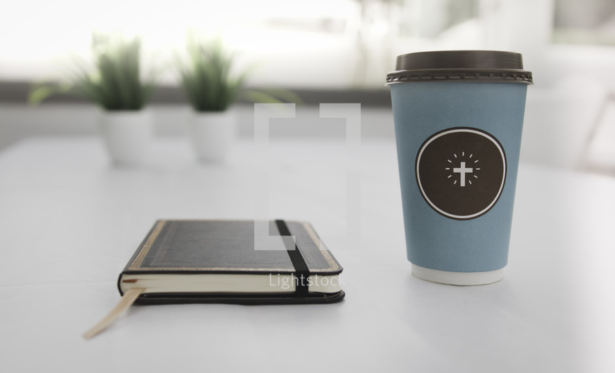 coffee cup with a cross and journal 