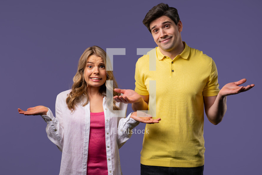 Confused man woman, couple shoulders up - can't help, makes gesture of dont know